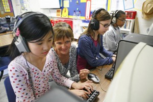 Meadow View Elementary School (Hardin County) 5th-grade teacher Laureen Laumeyer helps Eugena Kim with MISSION US. Also pictured are students Carla Narvaez and Terren Gamrell-Glover. MISSION US is a series of free, interactive online games plus materials for teaching American history. Photo by Amy Wallot; April 2011
