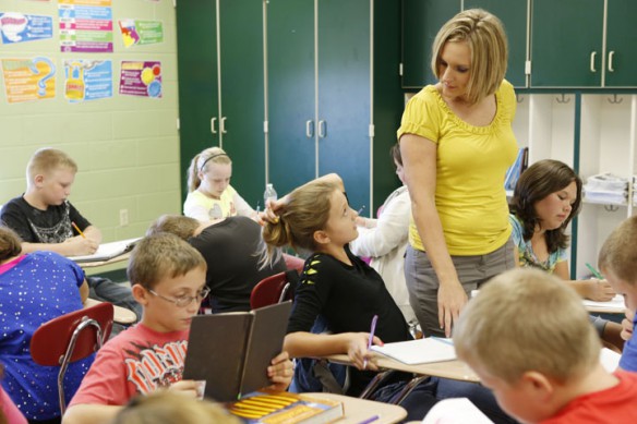 Tara Griffith helps 5th-grade student Hannah Cole with an assignment during her reading class.. Photo by Amy Wallot, Sept. 10, 2012