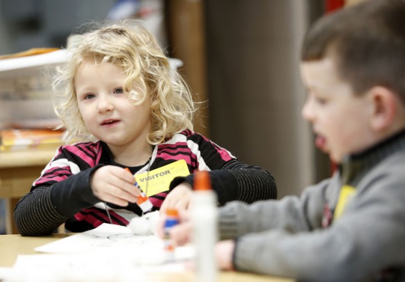 Claire Swihart uses a glue stick with cotton balls to make a snowman during the Little Stars program. Photo by Amy Wallot, Jan. 4, 2013