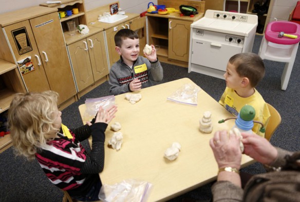 Eli Swihart uses play-doh to make a snowman during the Little Stars program at South Hancock Elementary School (Hancock County). Photo by Amy Wallot, Jan. 4, 2013