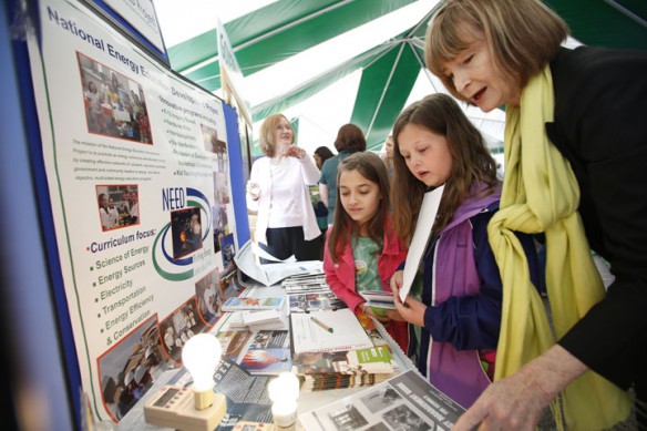 Mira Poposki and Kalyn Tackett, 4th-grade students at Northern Elementary (Scott County), visit with Pam Proctor at the Kentucky National Energy Education Development (NEED) during the Earth Day celebration at the Capitol.  Photo by Amy Wallot, April 22 , 2013