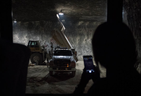 Sara Lainhart, a science teacher at Randall K. Cooper High School (Boone County), takes a picture of a truck drilling a blasting hole in the roof of the mine at Harrod Concrete and Stone Co. in Frankfort. Teachers got a tour of the mine as part of the Kentucky Crushed Stone Association's teacher workshop. Photo by Bobby Ellis, June 21, 2017