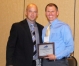 KAHPERD President Jamie Sparks congratulates Dennis Minnis, who was named the KAHPERD Elementary P.E. Teacher of the Year. Submitted photo by Jess Lawrence of Carin Guidance