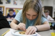 Fourth-grade student Abby Kellum \"mines\" chocolate chips from a cookie at Sutton Elementary School (Owensboro Independent) Feb. 4, 2011. As part of their lesson about rocks, minerals and the Earth\'s resources, the students did a \"Mining for Minerals\" lab where they \"mined\" chocolate chips from cookies. Sutton Elementary is a 2010 Distinguished Title I School. Photo by Amy Wallot