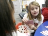 Third-grade students Savannah Helm, right, and Chloe Wood play Go Fish while working with mathematics intervention teacher Johnsie Tucker at Sutton Elementary School (Owensboro Independent) Feb. 4, 2011. Sutton Elementary was named a 2010 Distinguished Title I School. Photo by Amy Wallot