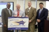 The Calloway County school district was recognized as a District of Distinction for the 2014-15 school year by the Kentucky Board of Education at its February meeting. Pictured at the presentation of the District of Distinction banner are, from left, William Twyman, KBE vice chairman; Brian Wilmurth, Calloway County district assessment coordinator; Tres Settle, Calloway County superintendent; and Stephen Pruitt, Kentucky education commissioner. Photo by Mike Marsee, Feb. 3, 2016