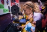 Virginia Richay, a 4th-grader at Field Elementary (Jefferson County) sets up a computer and 3-D printer at the STLP finals in Lexington. Photo by Bobby Ellis, April 22, 2016
