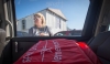 Elizabeth Harley prepares to grab a backpack out of the back of a van at another of her stops during Saffell Street Elementary School’s Home Visit Blitz. Homeroom teachers made their rounds with other school staff members, such as teachers without homerooms, the school secretary and the principal. Photo by Bobby Ellis, Aug. 8, 2016