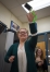 Luna Smith demonstrates the device helps secure an iPhone to the user’s wrist as Hailey Poe looks on. Photo by Bobby Ellis, April 7, 2016