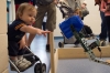 Lane Post reaches out of his stroller toward a robot arm during the World Maker and Inventor Expo at Boone County High School. Photo by Bobby Ellis, April 23, 2016