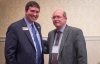 Education Commissioner Stephen Pruitt, left, congratulate Marco Muñoz, director of Priority Schools for the Jefferson County school district, at the Continuous Improvement Summit in Lexington. Southern High School, Frederick Law Olmsted Academy North and Seneca High School were all recognized for best practices. Photo by Bobby Ellis, Sept. 20, 2016