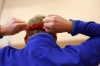 Paris High School (Paris Independent) teacher Stephen McCauley ties on a blindfold before running with a tethered partner. Photo by Amy Wallot, Feb. 25, 2015