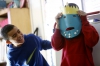 Tobias Johnson laughs as his partner Trent Bryan displays the Posiden mask they made for their presentation on Greek mythology during Lauren Coomes' 4th-grade class at Estes Elementary School (Owensboro Independent). 
Photo by Amy Wallot, Feb. 5, 2015
