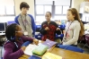 Fifth-grade students Dajianna Anderson, Dylan Peel, DeEunique Hinds and Shaylee Skaggs work on a skit demonstrating the vocabulary words amendment and security during Leslie Montgomery’s class at Atkinson Academy (Jefferson County). Photo by Amy Wallot, Feb. 5, 2013