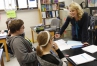 Tricia Shelton gives sophomores Donovan Sullivan and Karlie Roth a reading assignment after they finish an experiment during anatomy class at Boone County High School.They were to use the two pieces of evidence, the experiment and the article, to come to a conclusion about how body systems interact.  Photo by Amy Wallot, Sept. 17, 2014