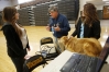 Veterinarian David Cleveland talks with sophomore Brittany Sauer about careers in animal science during Operation Preparation at Boyle County High School. Also pictured at right are veterinarian technician Chelsea Williams and Cleveland\'s dog Annie.  Photo by Amy Wallot, March 21, 2013