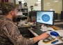 John Whitfill, a computerized manufacturing and machining instructor, looks at plans for the metal version of the logo. Photo by Bobby Ellis, Dec. 21, 2016