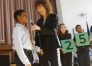 Fifth-grade student Jeremy Metcalf suggests an educator could by pencils and crayons with $25 as Milken Education Awards senior vice president Jane Foley starts to unveil the award amount during the Milken Family Foundation National Educator Award assembly at Breckinridge-Franklin Elementary School (Jefferson County).Photo by Amy Wallot, Jan. 15, 2015