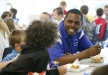 Berea College junior Collis Robinson talks with 1st-grade students during lunch at Camargo Elementary School (Montgomery County). Robinson originally thought he wanted to teach 5th grade but now enjoys the 1st grade as well. Photo by Amy Wallot, March 23, 2012