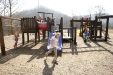 Children enjoy an unusually warm day during recess at Carr Creek Elementary School (Knott County) Feb. 17, 2011. The school\'s FRYSC raised money for the new playground. Photo by Amy Wallot