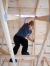 Jacob Quirantes, a junior, climbs into the rafters of the tiny house to take measurements during the building project. Photo by Bobby Ellis, Feb. 3, 2017