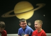 Hayes Lewis Elementary School (Leslie County) 6th-grade students Austin Feltner, left, and Jeremiah Caldwell listen to their flight plans in the briefing room at the Challenger Learning Center of Kentucky in Hazard Dec. 3, 2010. Photo by Amy Wallot