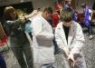 Hayes Lewis Elementary School (Leslie County) 5th-grade student Blake Stidham puts on a lab coat before taking off and landing at the space station at the Challenger Learning Center of Kentucky in Hazard Dec. 3, 2010. Photo by Amy Wallot