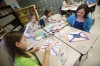 Third-grade students Alex Reynolds, Heiress Lehman, Beth Reynolds and Payton Nally paint in a dot style to mimic aboriginal art at Clay Elementary School (Webster County). Photo by Amy Wallot, Jan. 28, 2015