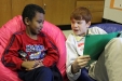Jefferson County Traditional Middle School student Tyler Lucas, right, reads to Navarro Walker, a 1st-grade student at Cochran Elementary School (Jefferson County). Photo by Justin Willis, March 6, 2012