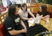 Commonwealth Middle College juniors Hannah Troutman, Rebecca Fountain and Loren Hale read entertainment news during lunch in the common area of West Kentucky Community and Technical College. Students can have lunch in the common area or a separate area only for the high school students. Photo by Amy Wallot, April 29, 2011