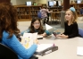 Teaching assistant Tanya Sizemore works on reading skills with 1st-grade students Brianna Moses and Aden McLain in the library. Photo by Amy Wallot, Dec. 2, 2014