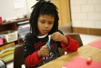 Second-grade student Vionte\' Miles cuts a shape for a collage during Rachel Losch\'s art class at Dixie Elementary Magnet School (Fayette County) Jan. 6, 2011. The students learned about Pablo Picasso and then were replicating his painting