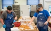 Morgan Wheeler, left, and Julie Barlow dip doughnut holes in chocolate while working at the Old School Café. Students earn minimum wage while working at the shop. Photo by Bobby Ellis, May 24, 2017