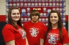 East Carter High School (Carter County) counselor Shelia Porter recognizes seniors who meet college or career readiness benchmarks with a bulletin board of ribbons and t-shirts. Amelia Robinson, Darrek Fannin and Katie Smith have all had their names placed on the board. All three are interested in medical professions. Photo by Amy Wallot, Dec. 12, 2014