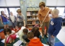 Debbie Lewis passes out tape to 2nd graders at Morningside Elementary School (Elizabethtown Independent) to use on models they designed to replicate an animal transferring pollen. Photo by Amy Wallot,  May 19, 2014