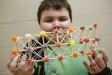 Jake Berry displays his team's gumdrop bridge made in Rebecca Logan's 5th-grade STEM class at Elkhorn Elementary School (Franklin County). Students studied bridge structures and the strengths of shapes to build a bridge that would hold the most pencils. Photo by Amy Wallot, Nov. 9, 2011