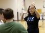 Audra Deli-Hoofnagle high-fives a team of 7th-grade students ater they finished a game where they had to run multiple times to the end of the gym and back to solve a puzzle at Elkhorn Middle School (Franklin County).Photo by Amy Wallot, Jan. 9, 2013