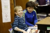 Brennan Wrath and William Stone laugh while reading Halloween by Jerry Seinfeld during Sarah Reed's 3rd-grade class at Field Elementary School (Jefferson County).Photo by Amy Wallot, Nov. 21, 2014