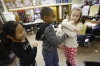 Emma Tucker, Steven Russell and Paige Franklin play with the class pet rat, Albany, during Sarah Reed's class. Franklin was taking the rat home for the weekend. Photo by Amy Wallot, Nov. 21, 2014