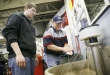 Franklin County High School senior Devin Green and automotive technology teacher Francis Wheatley wash their hands using the soap that is made as a byproduct of making biodiesel fuel at the Franklin County Career and Technology Center. Photo by Amy Wallot, Jan. 30, 2012