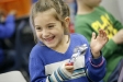 Kindergarten student Karina Carmona keeps the beat to “If You\'re Happy and You Know It” with spoons during music class at Gamaliel Elementary School (Monroe County). Photo by Amy Wallot, Feb. 2, 2012