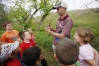 Eastern Kentucky University Assistant Professor David Brown holds a robin as he shows students at Glenn Marshall Elementary School (Madison County) how to catch and band birds. Photo by Amy Wallot, May 9, 2014