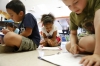 Second-grade students Caleb Trejo, Talynn Burton and Shayden Anderson read out loud as a group for fluency practice.  Photo by Amy Wallot, May 7, 2015