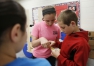 Sixth-grade students Alli Atwell, Macy Helton and Mason Moore check the pH levels of the school's aquaponics system at Bryan Station Middle School (Fayette County). Photo by Amy Wallot, May 8, 2015