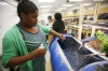 Science teacher Thomas Reed helps 6th-grade students Jamez Brooks and Antyana Cowan determine the pH levels of the tilapia tank as part of the aquaponics system at Bryan Station Middle School (Fayette County).  Photo by Amy Wallot, May 8, 2015