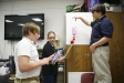 Seventh-grade student Foster Burden uses an iPad to record data with partners Madison King and Jared Mueller during an experiment in Leann Brannock’s class at Harrison County Middle School. Photo by Amy Wallot