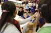 Fifth-grade students Gabriel Jones and Maxwell Jaggers listen to DuPont Manual High School (Jefferson County) students teach science concepts in Spanish. Photo by Amy Wallot Nov. 19, 2014