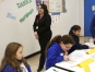 Ana Castro, Spanish teacher at DuPont Manual High School (Jefferson County), works the room checking on her students as they teach science lessons to elementary students at Hawthorne Elementary School. Photo by Amy Wallot Nov. 19, 2014