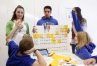 DuPont Manual High School (Jefferson County) seniors Bianca Menendez, Issac Domenech and Neela Saha teach the period table of the elements in Spanish to Hawthorne Elementary School students. Photo by Amy Wallot Nov. 19, 2014