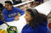Fifth-grade student Nina Valdez smiles while answering science questions with DuPont Manual High School senior Issac Domenech as part of their Spanish Immersion program.  Photo by Amy Wallot Nov. 19, 2014